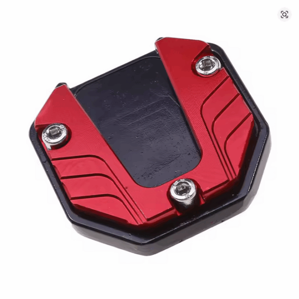 Motorcycle kickstand extender made of aluminum, shown as a small, flat support pad designed to increase the surface area of a side stand, placed against a neutral background.