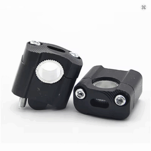 CNC machined handlebar clamp risers designed to adapt 22mm handlebars to 28mm fat bar mounts for dirt bikes, shown against a neutral background.